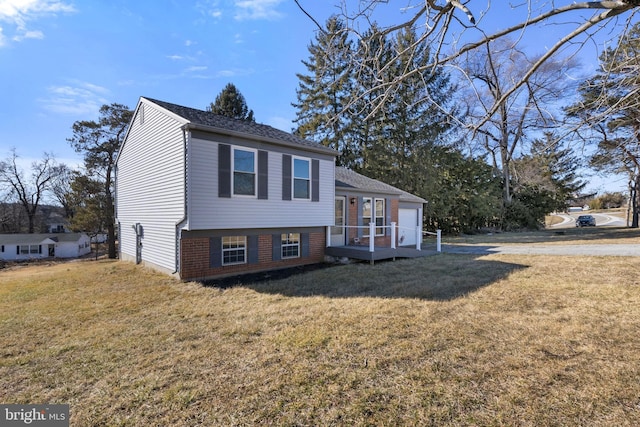 view of front of home with a front lawn and a garage