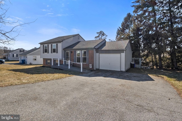 split level home with a front lawn and a garage