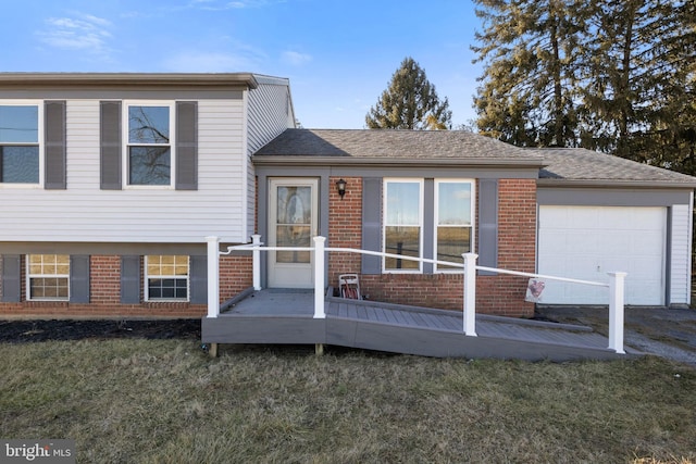 split level home with a garage and a front lawn