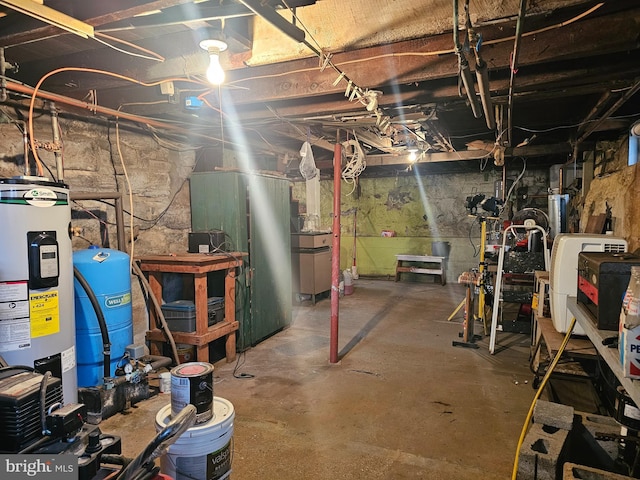 unfinished below grade area featuring water heater