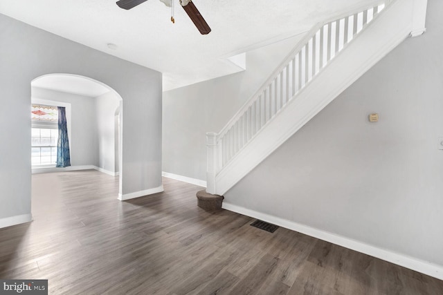 interior space with dark wood-type flooring and ceiling fan