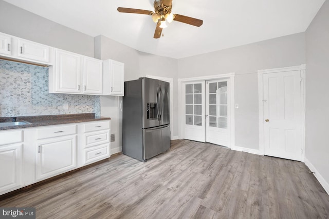 kitchen with ceiling fan, white cabinetry, stainless steel refrigerator with ice dispenser, light hardwood / wood-style floors, and french doors