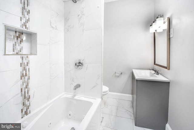 full bathroom featuring vanity, tiled shower / bath, and toilet