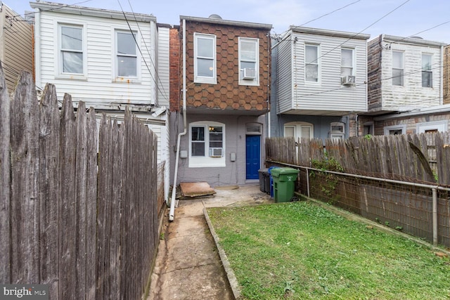 rear view of house featuring a lawn