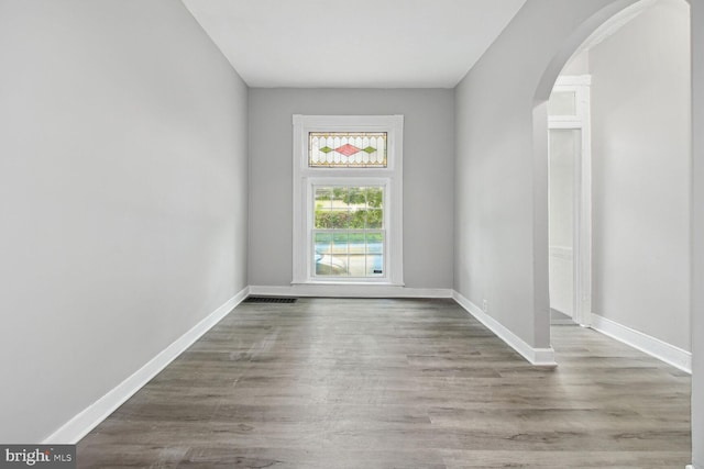 unfurnished room with light wood-type flooring