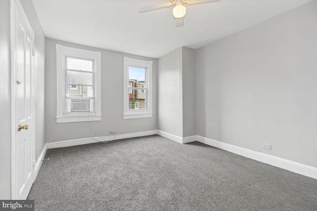 carpeted spare room featuring cooling unit and ceiling fan