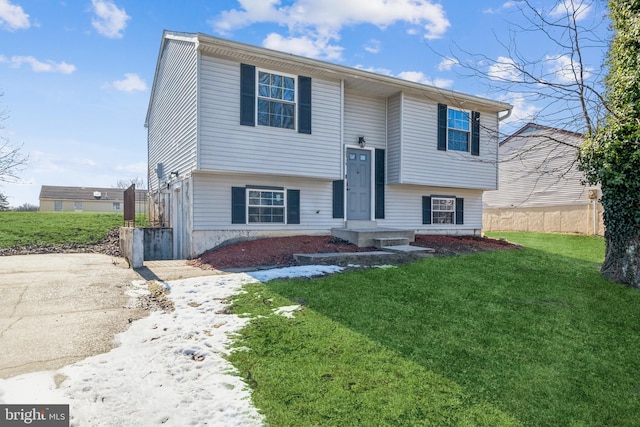 raised ranch with a front yard