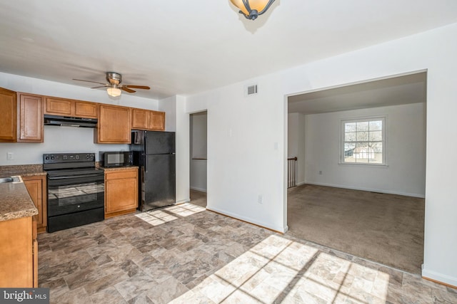 kitchen with light colored carpet, black appliances, and ceiling fan