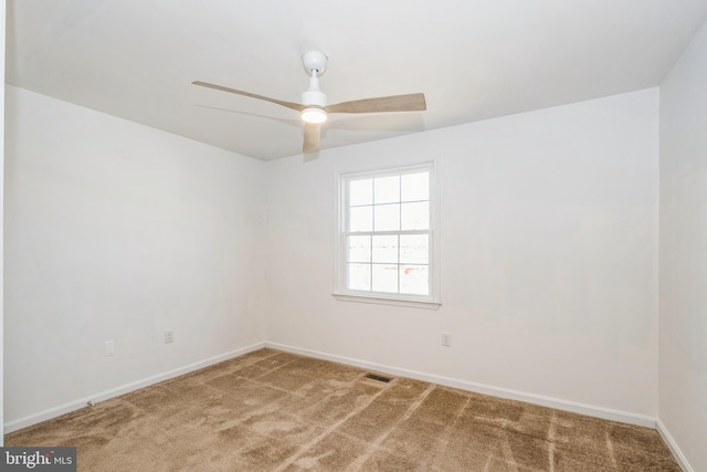 empty room featuring carpet floors and ceiling fan