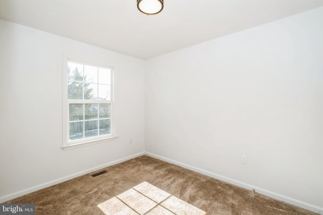 spare room featuring carpet floors