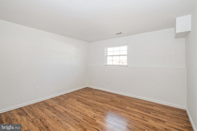 unfurnished room featuring hardwood / wood-style floors