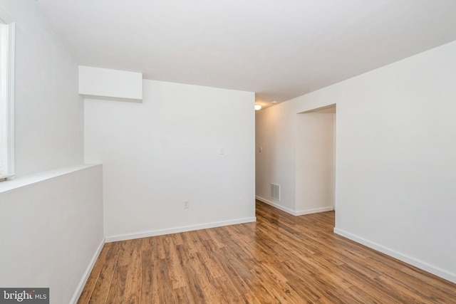 spare room with hardwood / wood-style flooring