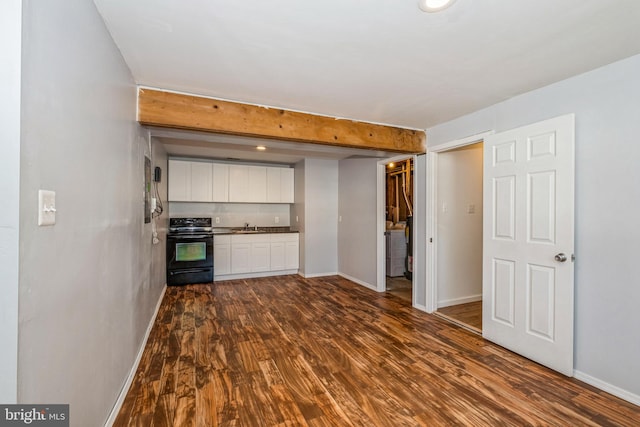 kitchen with sink, beam ceiling, electric range, dark hardwood / wood-style floors, and white cabinets