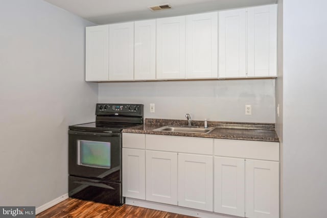 kitchen featuring white cabinetry, black range with electric stovetop, sink, and dark hardwood / wood-style flooring