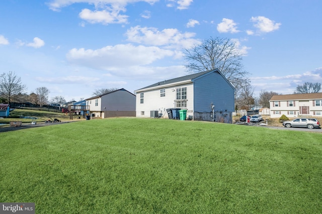 exterior space featuring central AC and a lawn