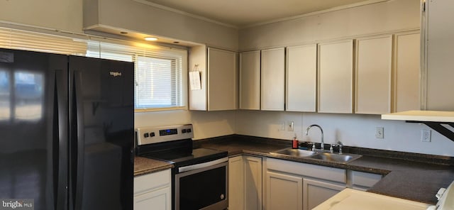 kitchen featuring sink, ornamental molding, white cabinets, black fridge, and stainless steel range with electric cooktop