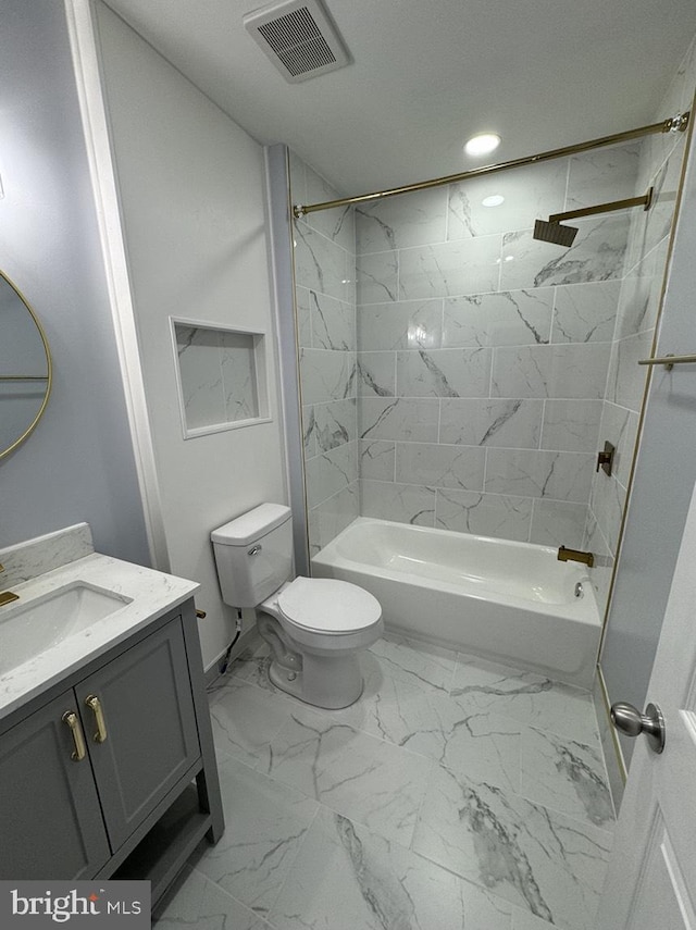 full bathroom with vanity, toilet, and tiled shower / bath