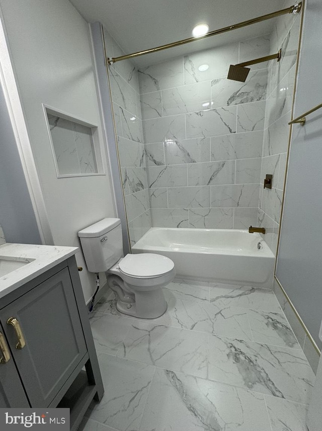 full bathroom featuring tiled shower / bath combo, vanity, and toilet