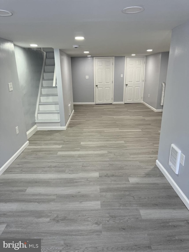 basement with light hardwood / wood-style floors