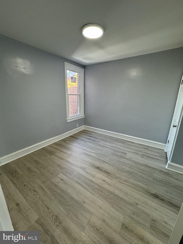 empty room with light hardwood / wood-style flooring