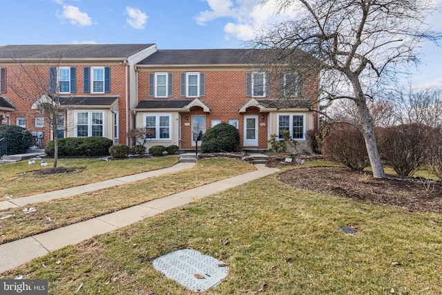 view of property featuring a front lawn