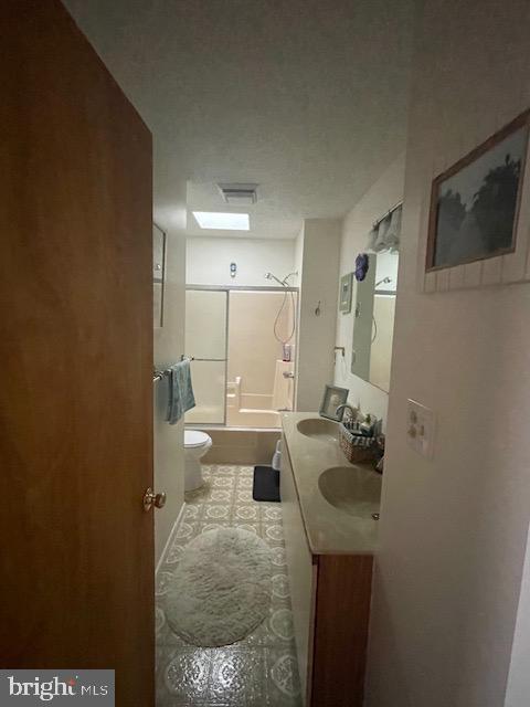 full bathroom featuring shower / bathing tub combination, vanity, and toilet