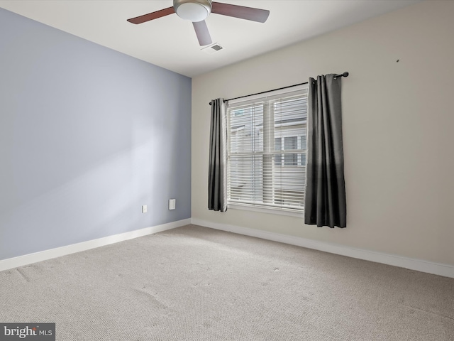 carpeted spare room with ceiling fan