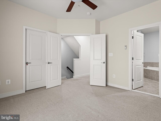 unfurnished bedroom featuring light carpet and ceiling fan