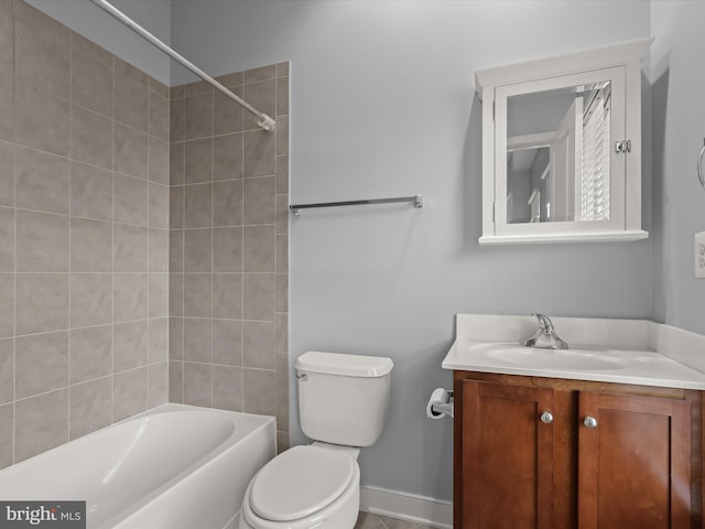 full bathroom featuring vanity, tiled shower / bath combo, and toilet