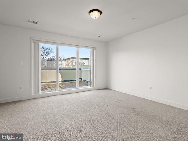 carpeted spare room with a water view