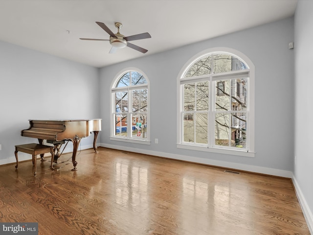 interior space featuring hardwood / wood-style floors and ceiling fan