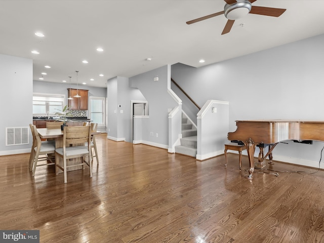 dining room featuring wood-type flooring and ceiling fan