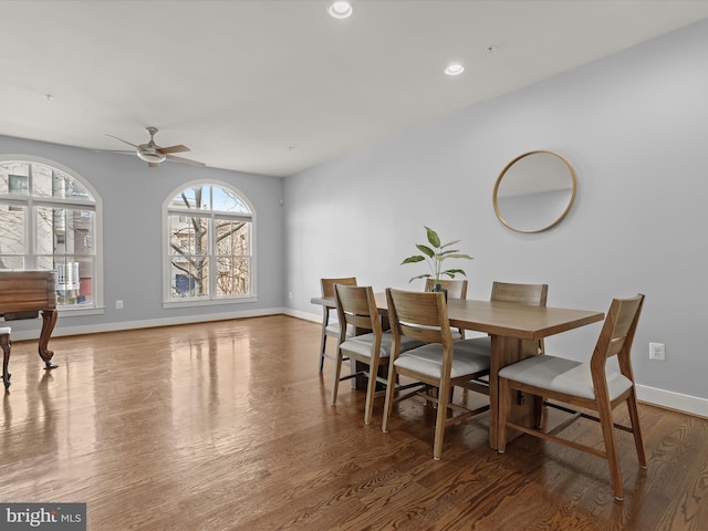 dining space with dark hardwood / wood-style flooring and ceiling fan