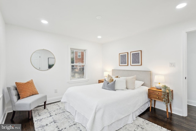 bedroom with baseboards, wood finished floors, and recessed lighting