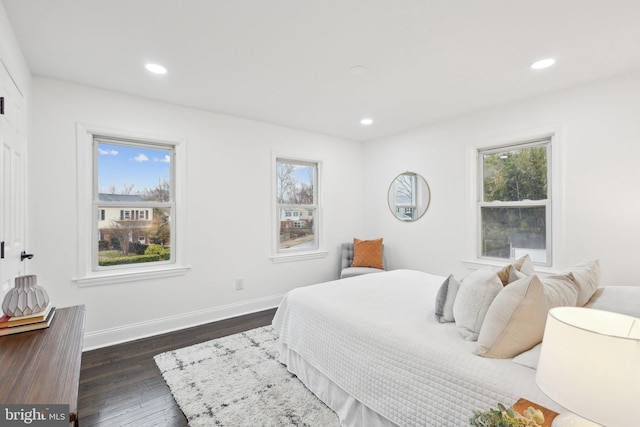 bedroom featuring multiple windows, baseboards, dark wood-type flooring, and recessed lighting