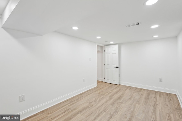 finished below grade area with recessed lighting, visible vents, baseboards, and wood finished floors