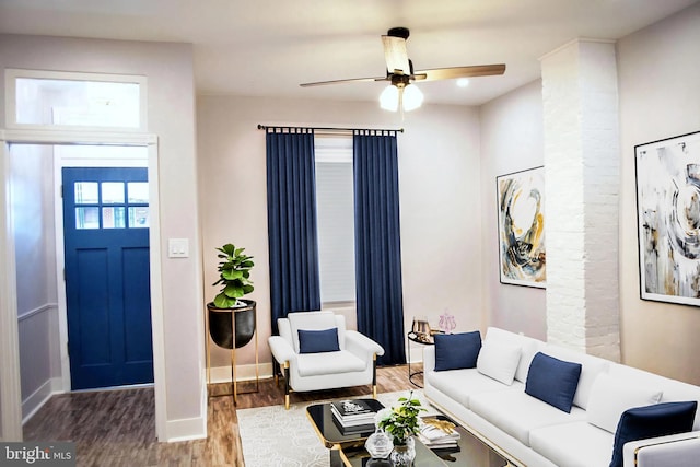 living room featuring ceiling fan and wood-type flooring