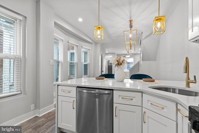 kitchen featuring sink, white cabinets, dark hardwood / wood-style flooring, decorative light fixtures, and stainless steel dishwasher