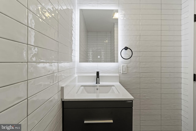 bathroom with tile walls and vanity