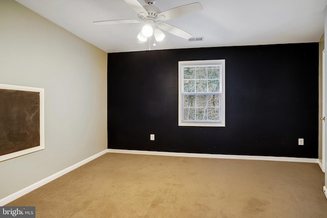 unfurnished room with ceiling fan and light carpet