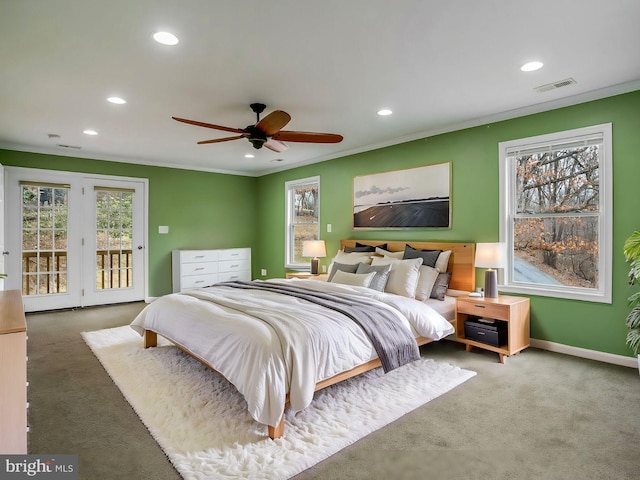 carpeted bedroom featuring crown molding, ceiling fan, multiple windows, and access to outside