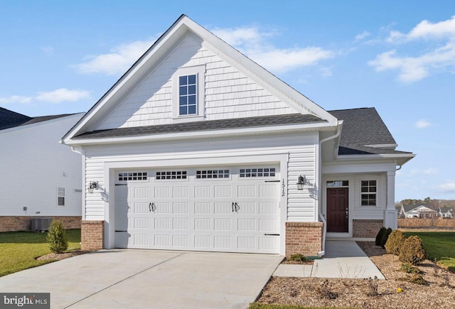 craftsman-style house featuring central AC and a garage