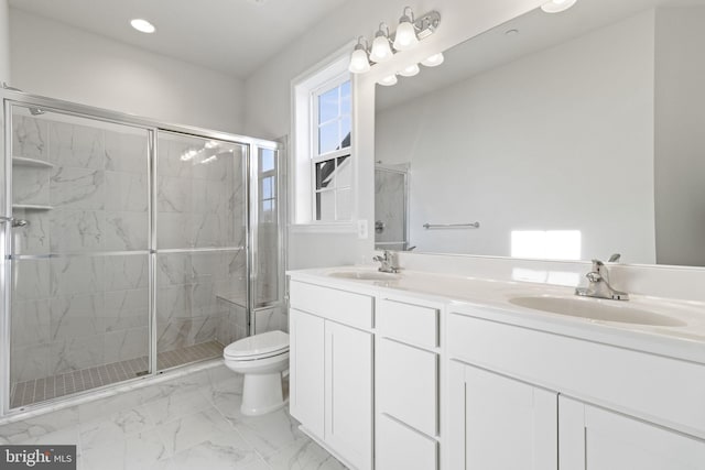 bathroom featuring vanity, toilet, and walk in shower