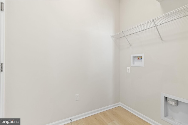 laundry area with hardwood / wood-style flooring and washer hookup