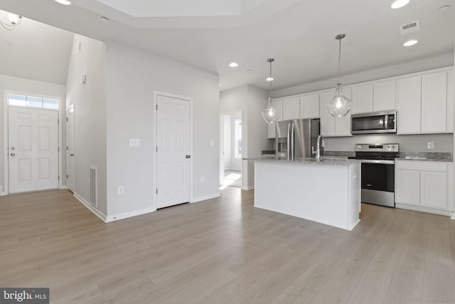 kitchen with white cabinetry, an island with sink, appliances with stainless steel finishes, and hanging light fixtures