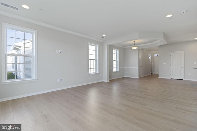 unfurnished living room with ornamental molding and light hardwood / wood-style floors