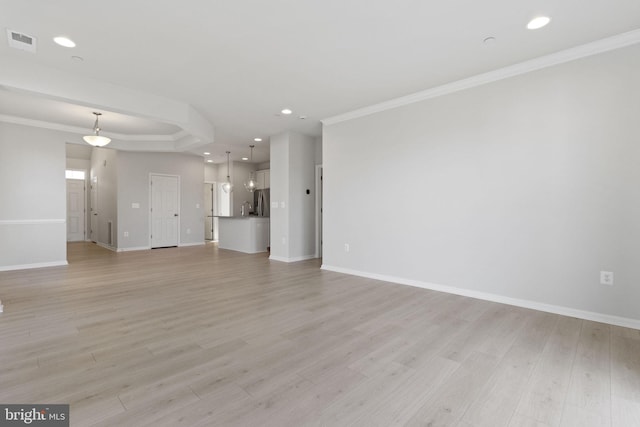 unfurnished living room with crown molding, sink, and light wood-type flooring