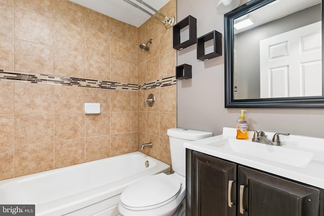 full bathroom with tiled shower / bath, vanity, and toilet