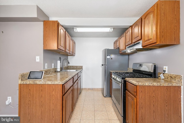 kitchen with stainless steel appliances, light tile patterned flooring, and sink