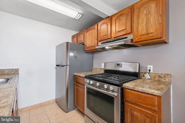 kitchen featuring stainless steel appliances and light tile patterned floors